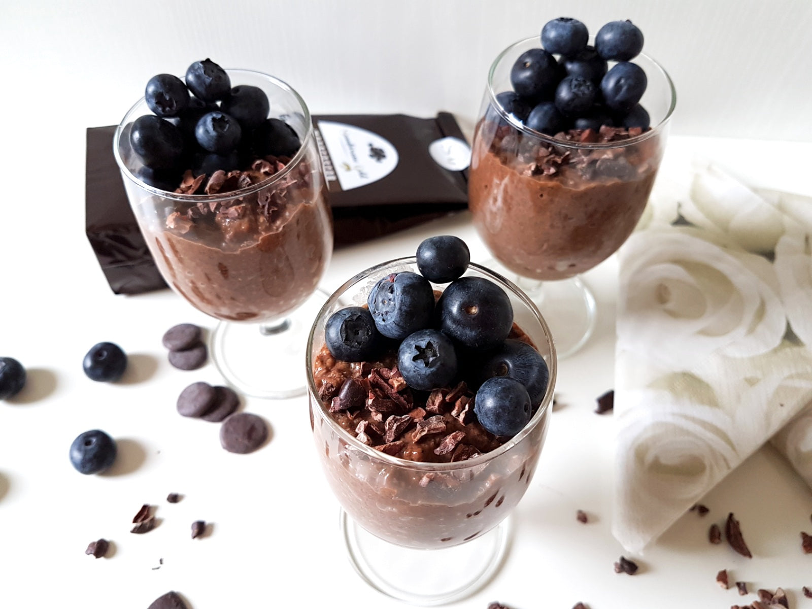 Dark chocolate chia pudding with blueberries and cocoa beans